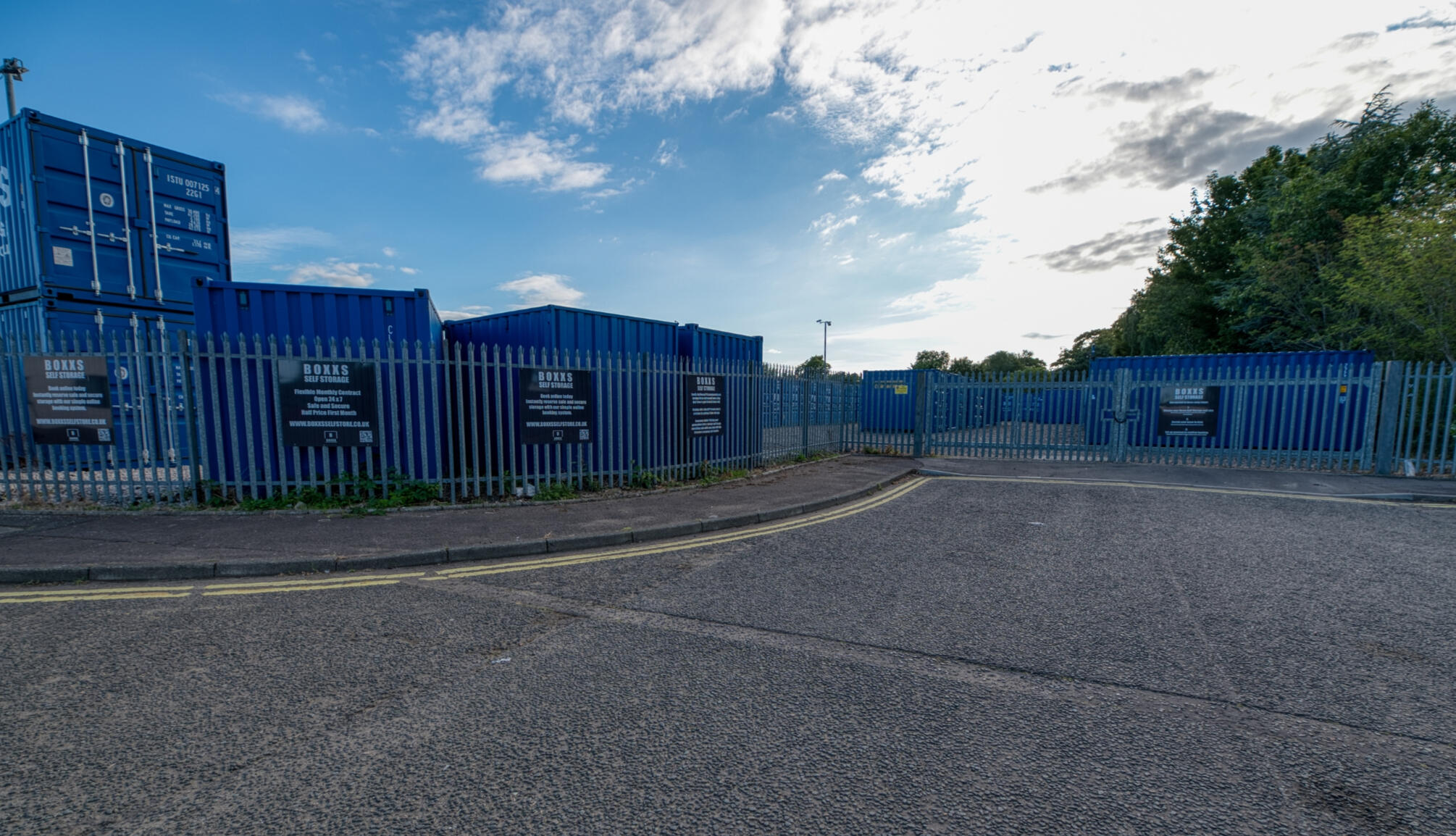 Entrance to Boxxs Self Storage Linlithgow with secure fenced yard Entrance to Boxxs Self Storage in Linlithgow showing containers, secure fenced yard, and gated access for Polmont customers