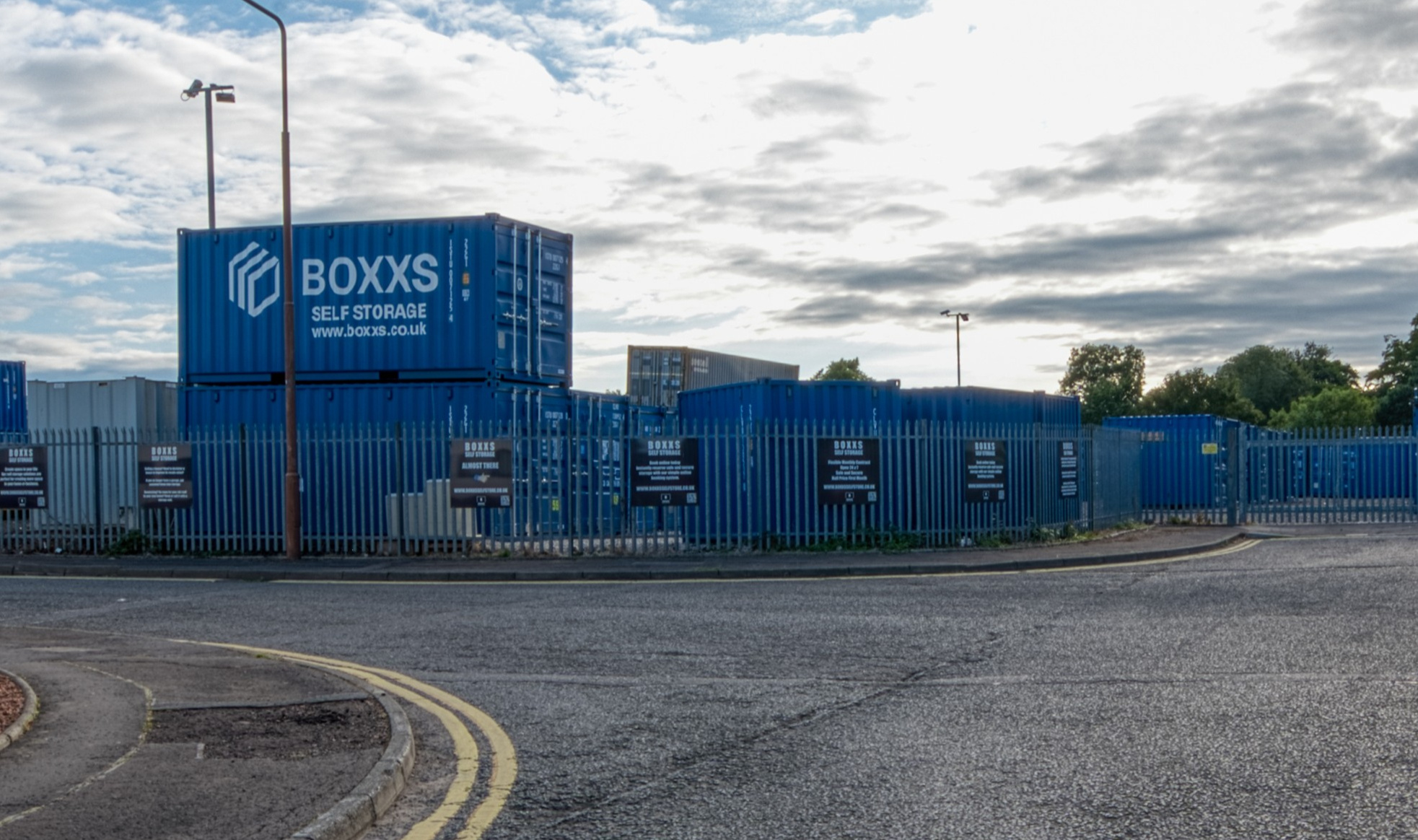 Alternate angle of Boxxs self storage container with painted logo at the Linlithgow entrance, highlighting secure access for Polmont and Falkirk customers